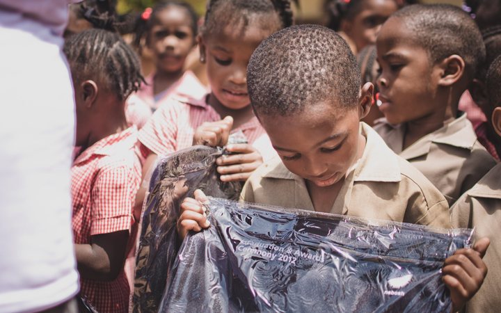 Jamaican schoolchildren opening the bags they received