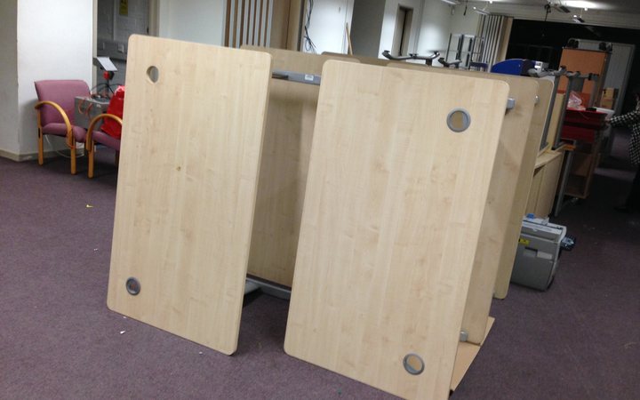 Desks donated by the BBC waiting to be shipped